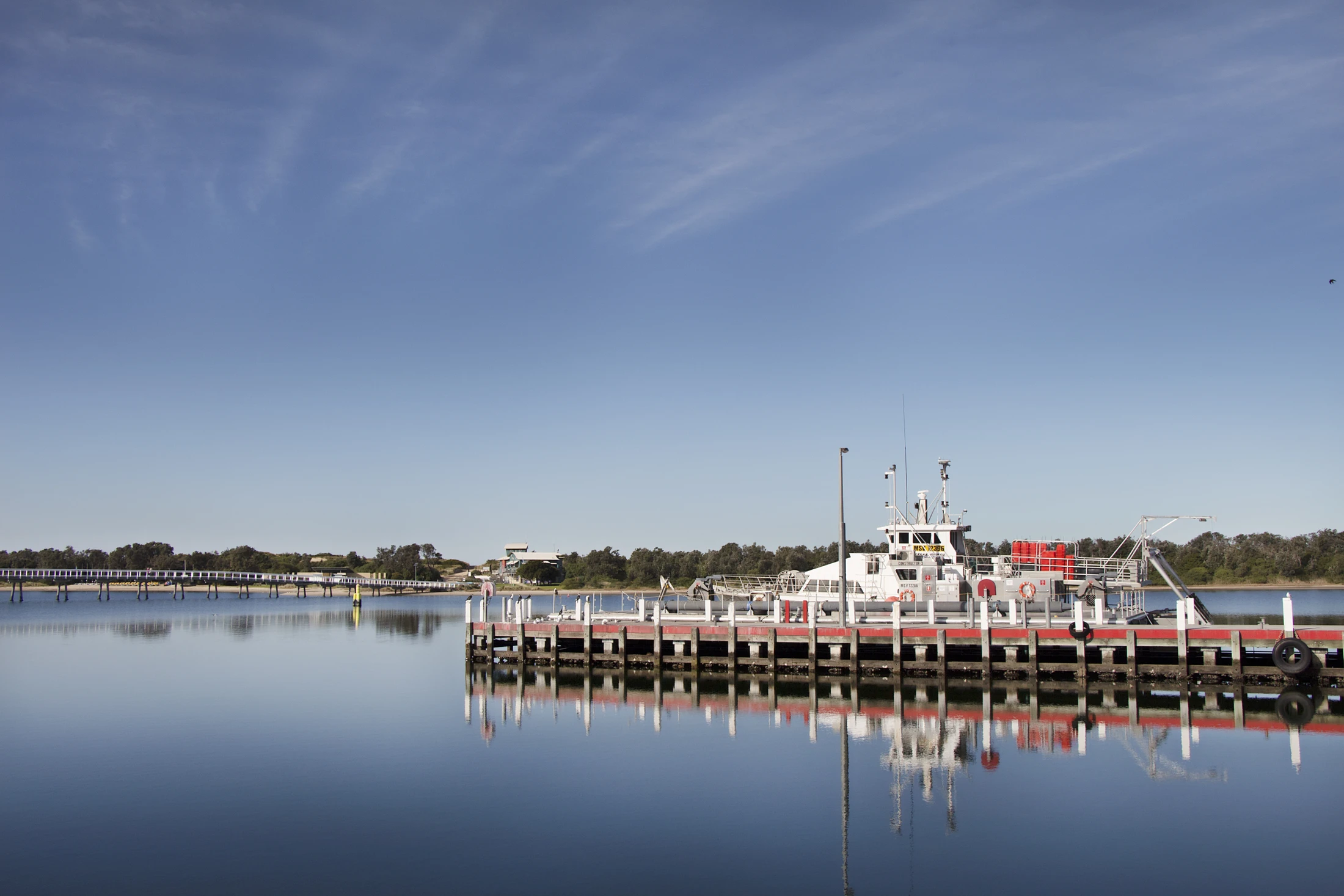 A vessel moored on a calm Lakes Entrance morning
